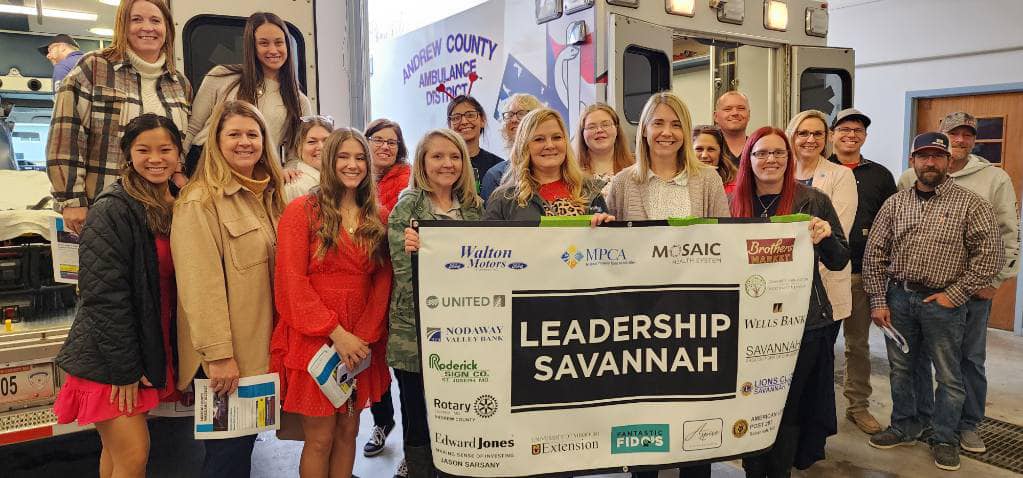 Leadership Savannah participants gathered with a community banner